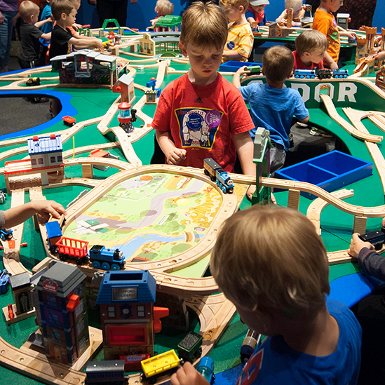 children playing with the train table